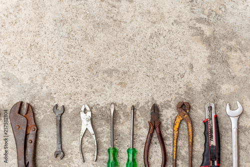 Many carftsman tools that are placed on the cement floor.