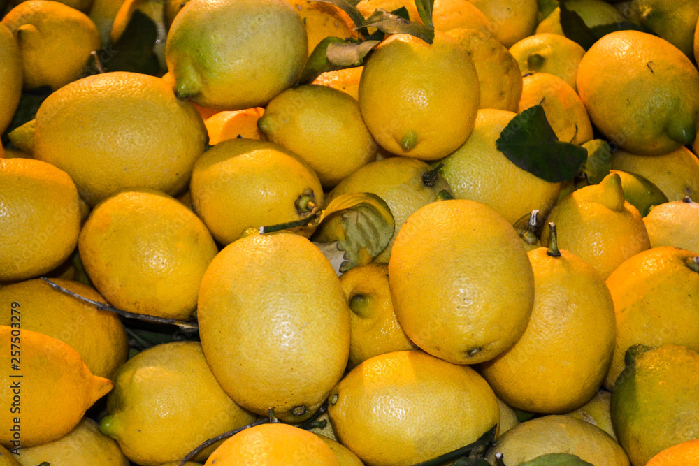 Ripe yellow lemons, lie background in the bazaar.