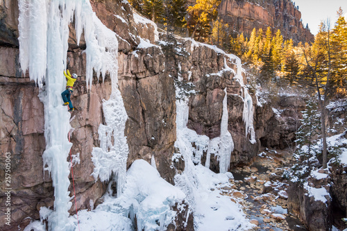 Woman ice climbing near Ouray, Colorado photo