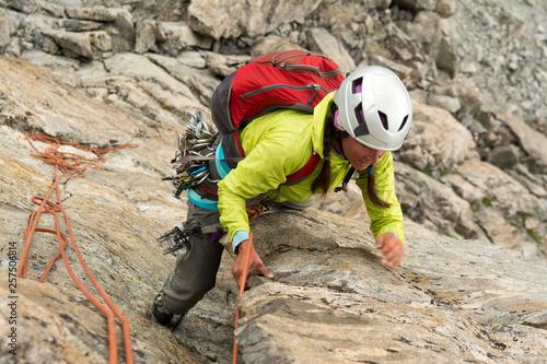 A woman rock climber in Titcomb Basin, WInd River Range, Pinedale, Wyoming. photo