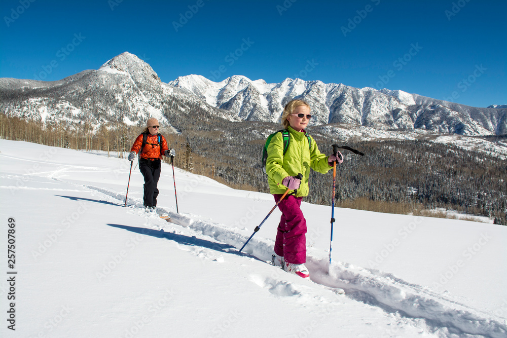 A mother and daughter backcountry skiing in the San Juan National Forest, Durango, Colorado.