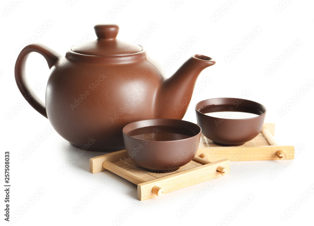 Cups and teapot of freshly brewed oolong on white background