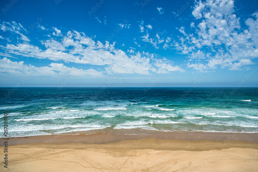 Obraz premium Yellow sand beach, sea and deep blue sky