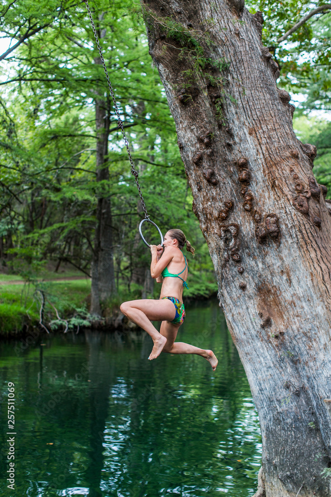 The Blue Hole in Wimberley, Texas is a popular destination for tourists and locals on hot summer days. The clear, cool water flows through cypress trees and offers a refuge from the Texas heat. The Blue Hole in Wimberley, Texas is a popular destination for tourists and locals on hot summer days. The clear, cool water flows through cypress trees and offers a refuge from the Texas heat.