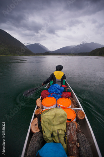 Canoeing in the rain across McLeary Lake during a multi-day canoe trip through Bowron Lake Provincial Park. photo