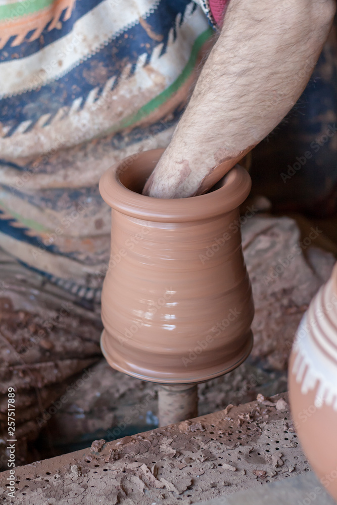 ceramic workshop - the man makes a pot of clay on a potter's wheel ceramic workshop - the man makes a pot of clay on a potter's wheel