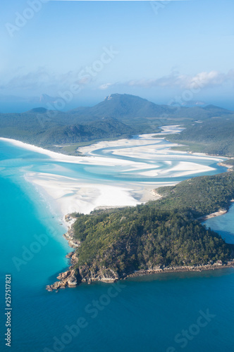 Wall Mural aerial view over whitsunday island beach with blue sunny sky and white sand at w