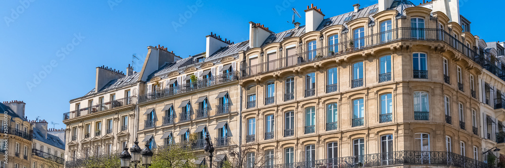 Paris, beautiful building in the Marais, typical parisian facade and windows