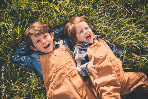 Two brothers lying on meadow photo