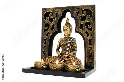 Bilde på lerret Buddha sculpture with golden color in decorative frame with candles and overall