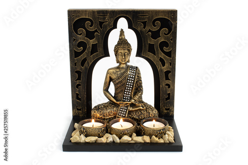 Bilde på lerret Buddha sculpture with golden color in decorative frame with candles and stones a