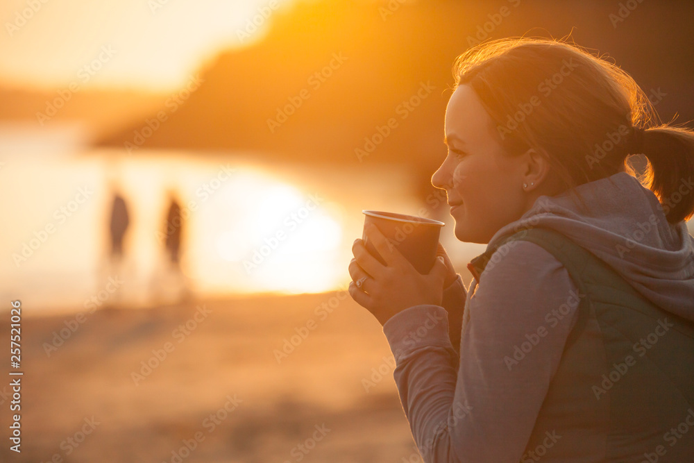 A Woman Enjoying A Hot Drink At A Beach Near Tofino, British Columbia, Canada