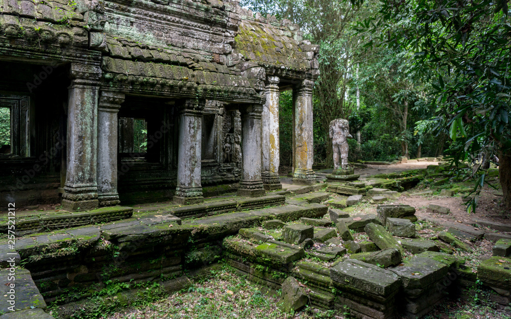 Moss covered temple and statue at the Angkor Unesco World Heritage site Moss covered temple and statue at the Angkor Unesco World Heritage site
