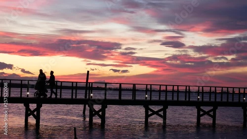 Wallpaper Mural Lesina, Gargano National Park, Apulia, Italy - March 11 2019: people walk on jatty on (lake) lagoon at sunset. Torontodigital.ca