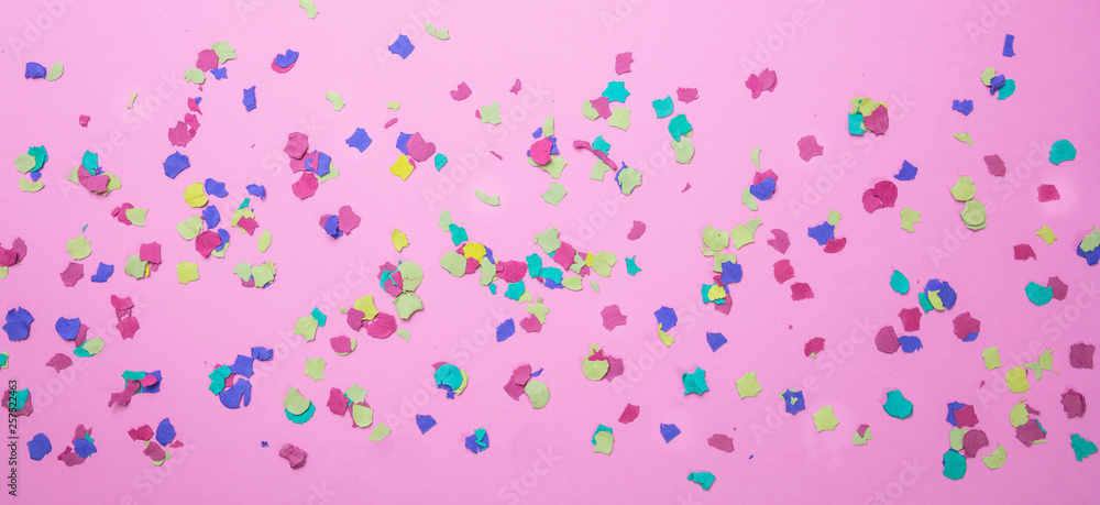 Carnival, birthday party. Colorful confetti on pink background Carnival, birthday party. Colorful confetti on pink background