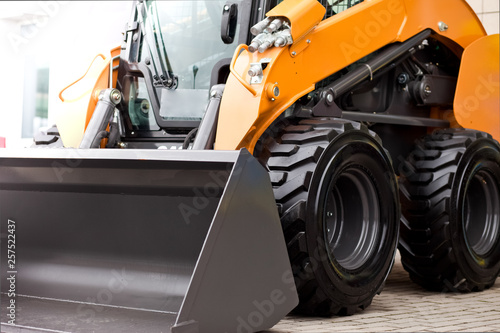 Fotografi Mini skid loader.  Small bulldozer. Construction machinery