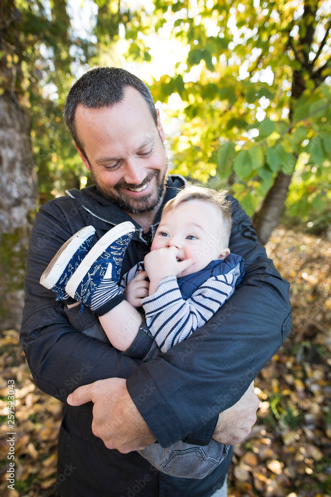 Father holding son in park Father holding son in park