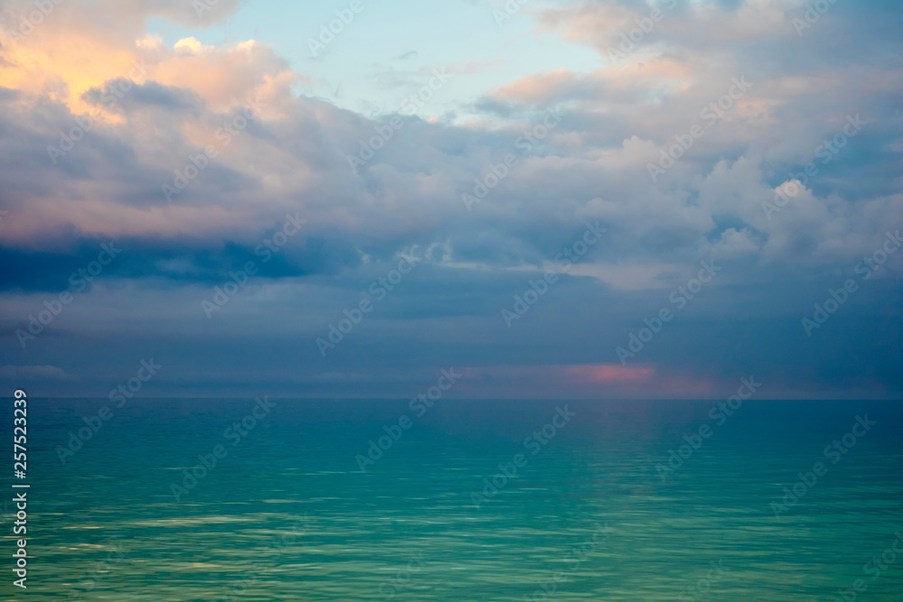 Storm clouds over calm ocean at dawn, Boracay, Philippines Storm clouds over calm ocean at dawn, Boracay, Philippines