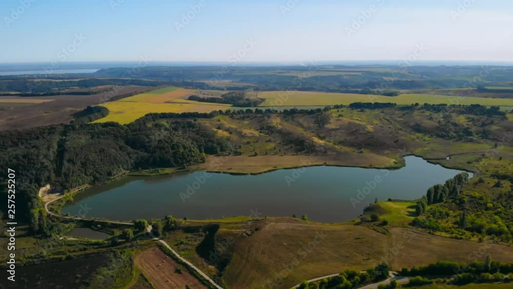 aerial view on the lake surrounded trees beautiful nature landscape with field river and blue skyline aerial view on the lake surrounded trees beautiful nature landscape with field river and blue skyline
