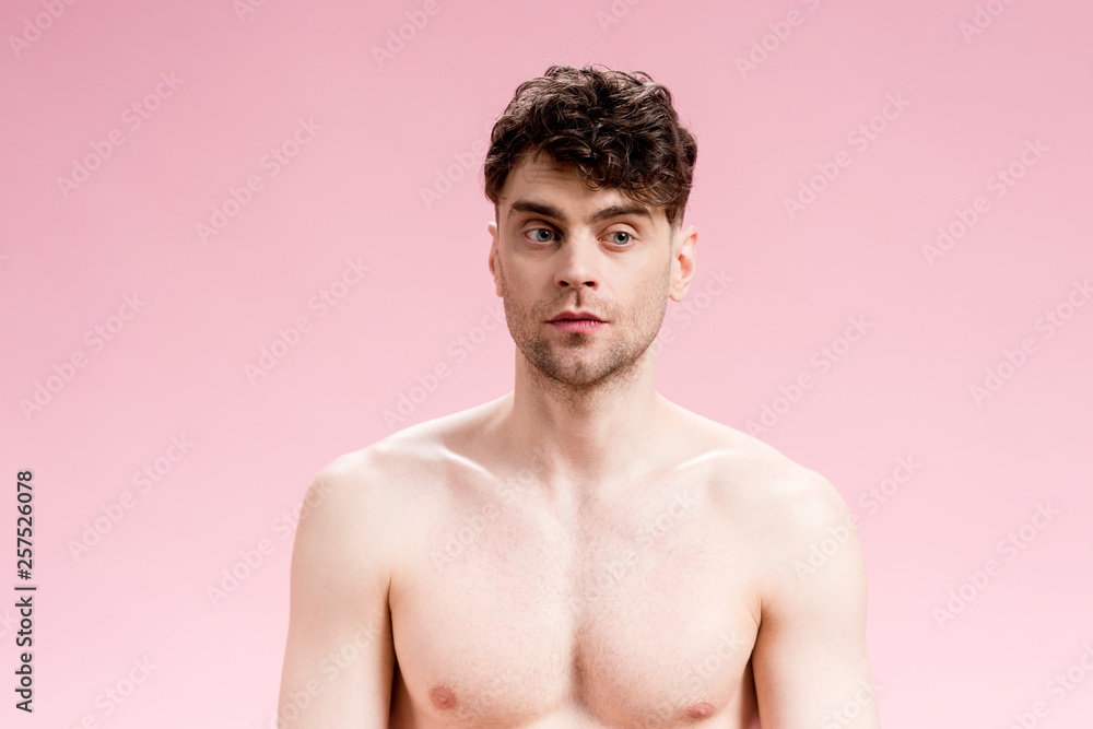 Fototapeta premium handsome, serious and confident brunette man on pink