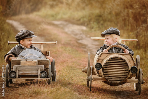 Competition between the two boys on improvised racing cars photo