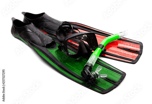 Mask, snorkel and swim flippers of different colors with water drops