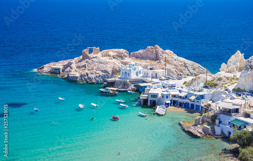 Scenic Firopotamos village (traditional Greek village by the sea, the Cycladic-style) with sirmata - traditional fishermen's houses, Milos island, Cyclades, Greece. photo