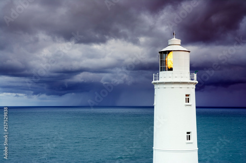 Lighthouse against stormy sky