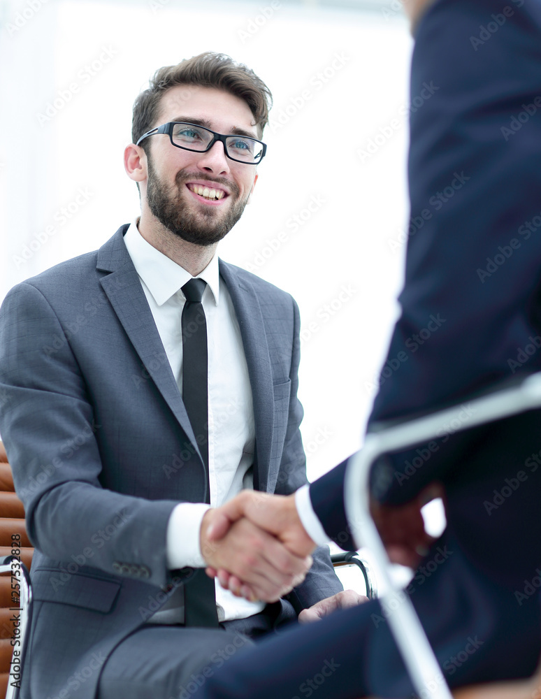 wo focused coworkers sitting together in a modern office wo focused coworkers sitting together in a modern office