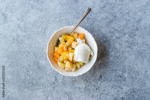 Fruit Salad with Vanilla Ice Cream in Ceramic Bowl.