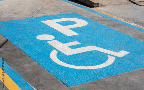 handicapped icon on the ground of car parking area reserve for disabled people in urban gas station, disability access healthcare
