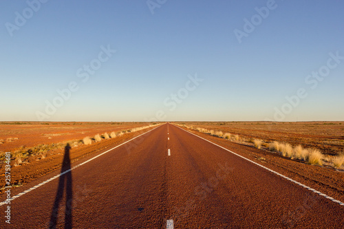 red straight road with red dessert on the Stuart Highway north of copper pedy, South Australia,