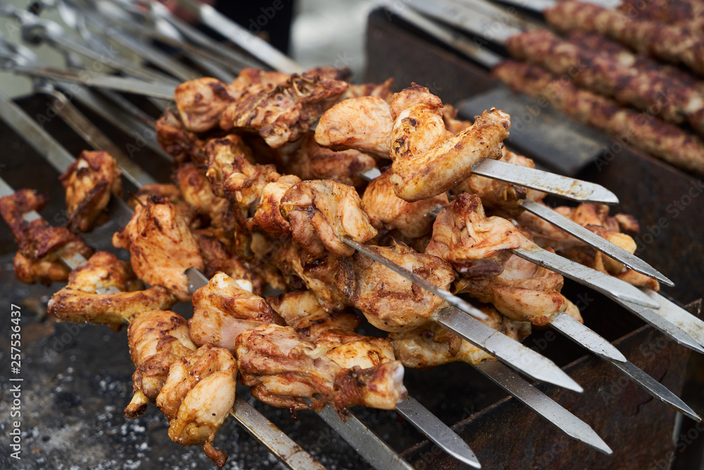 Roasted chicken wings meat kebab on skewers, close-up