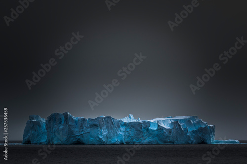Iceberg under gray sky, Gerlache Strait, Antarctica photo