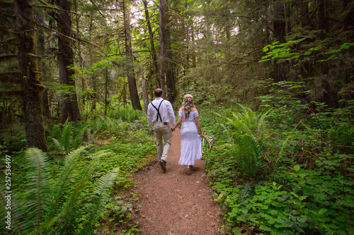 Bride and groom in forest on hiking trail to Fall Creek Falls, North Umpqua National Forest, Oregon, USA photo