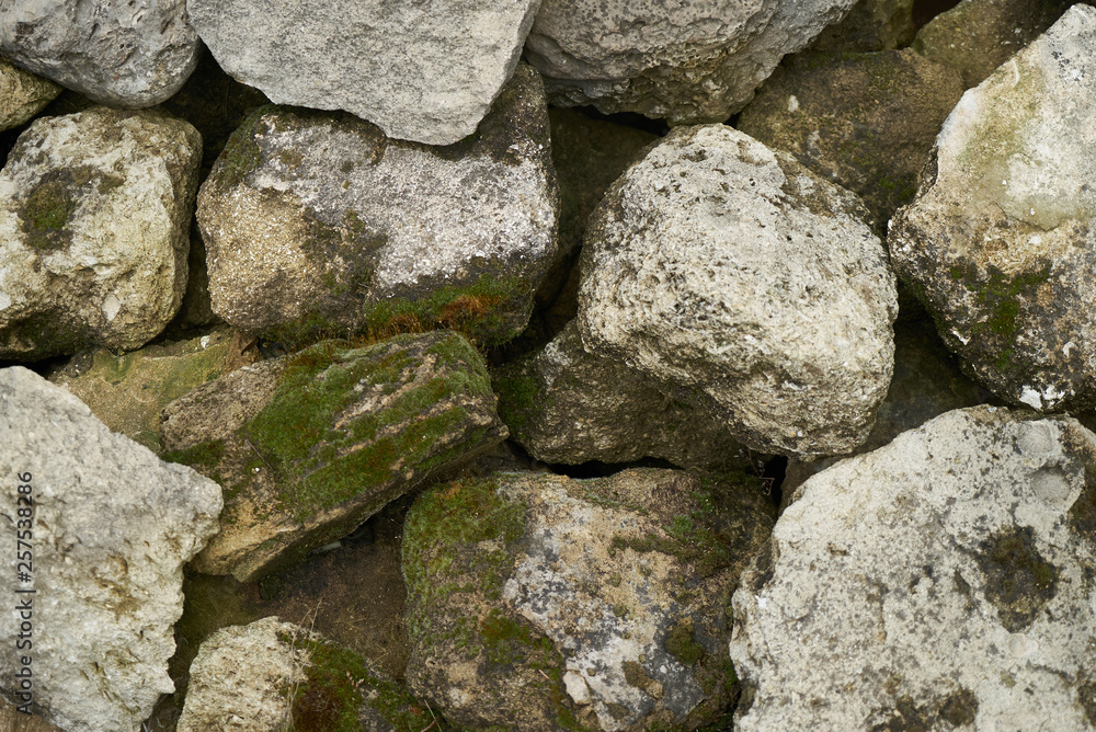 Old moss covered river stones background texture