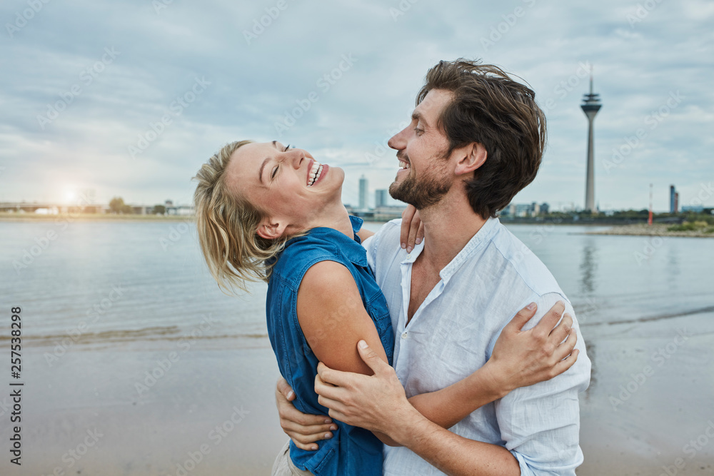 Germany, Duesseldorf, happy young couple at Rhine riverbank Germany, Duesseldorf, happy young couple at Rhine riverbank