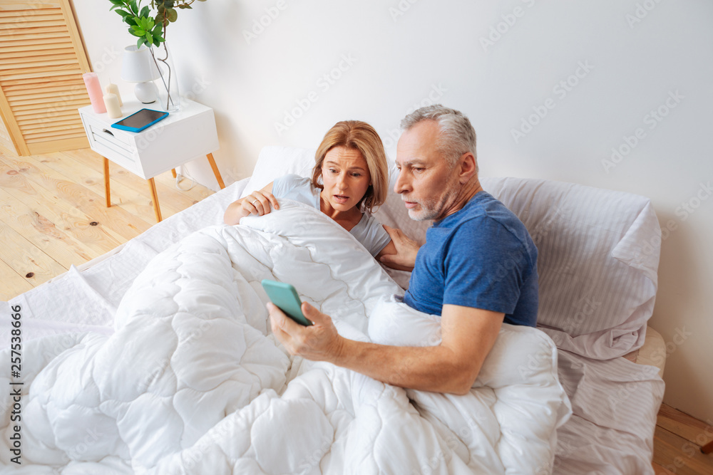 Fototapeta premium Businessmen after seeing disturbing message from daughter