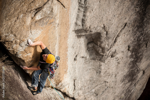 Man lead climbing a two pitches crack route in trad style, where only friends and nuts are allowed to protect the progression. Cadarese is a granite crag located in Premia, Ossola Valley, and is growing to one of the best european destination for trad and crack climbing.