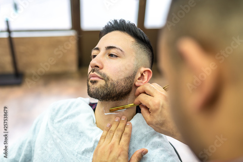 Young Man Getting a Beard Shaved © MCStock