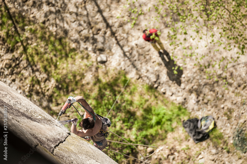 Lucas Iribarren bolting a new route in Premia's crag. Premia, Piemonte, Italy. Lucas Iribarren bolting a new route in Premia's crag. Premia, Piemonte, Italy.