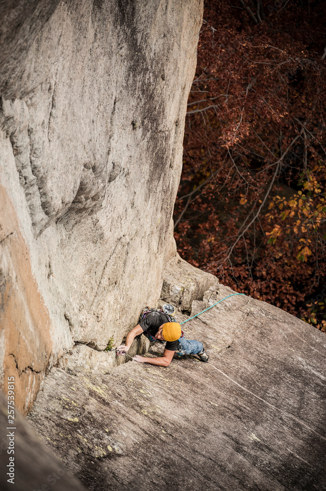 Man lead climbing a two pitches crack route in trad style (that means that only self-placed gear like friends and nuts is allowed for protect the ascent) in Cadarese, Ossola Valley, Italy. Man lead climbing a two pitches crack route in trad style (that means that only self-placed gear like friends and nuts is allowed for protect the ascent) in Cadarese, Ossola Valley, Italy.