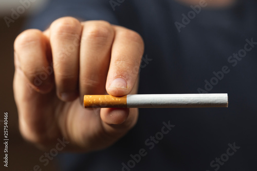 Hand holding a cigarette close-up view