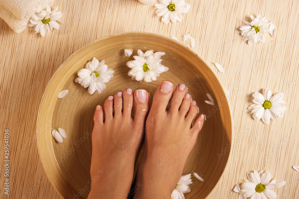 The picture of ideal done manicure and pedicure. Female hands and legs in the spa spot. The picture of ideal done manicure and pedicure. Female hands and legs in the spa spot.