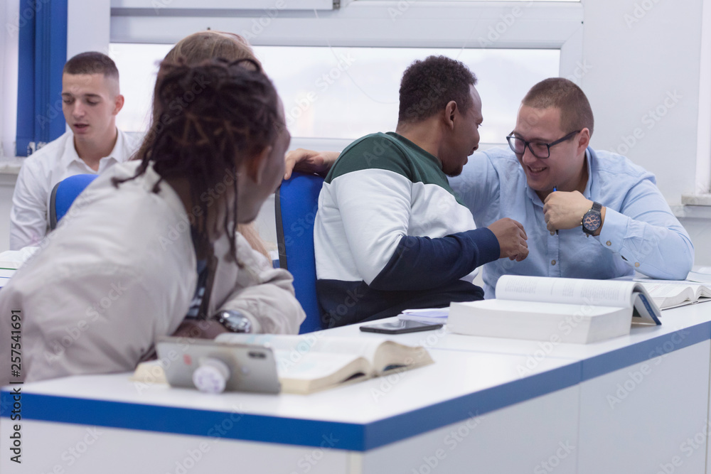 Fototapeta premium University Students during the class. Resolving problems together. Team work concept.