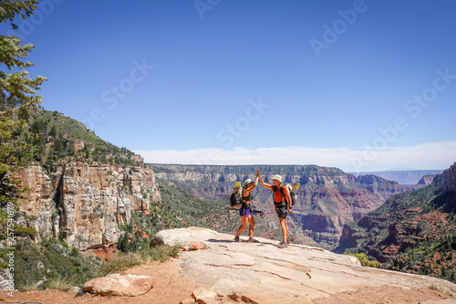 Hikers high fiving in Grand Canyon, Arizona, USA photo