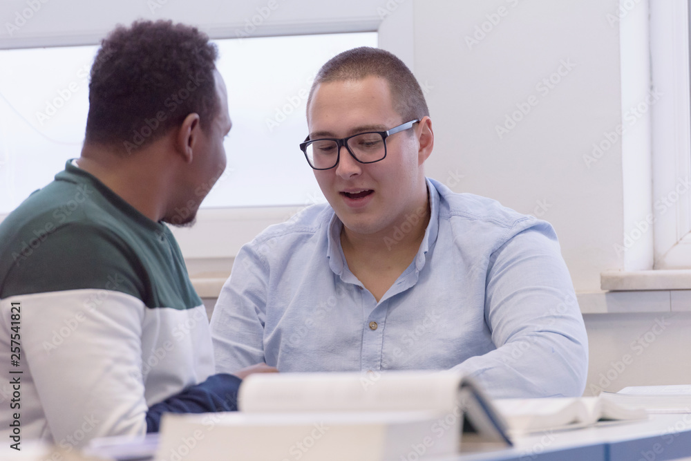University Students during the class. Resolving problems together. Team work concept. University Students during the class. Resolving problems together. Team work concept.