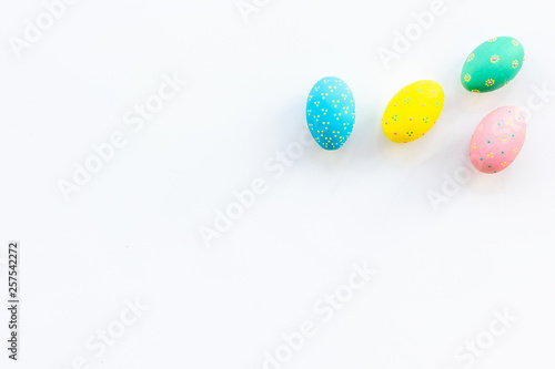 Easter celebration with colorful eggs on white background top view mock up