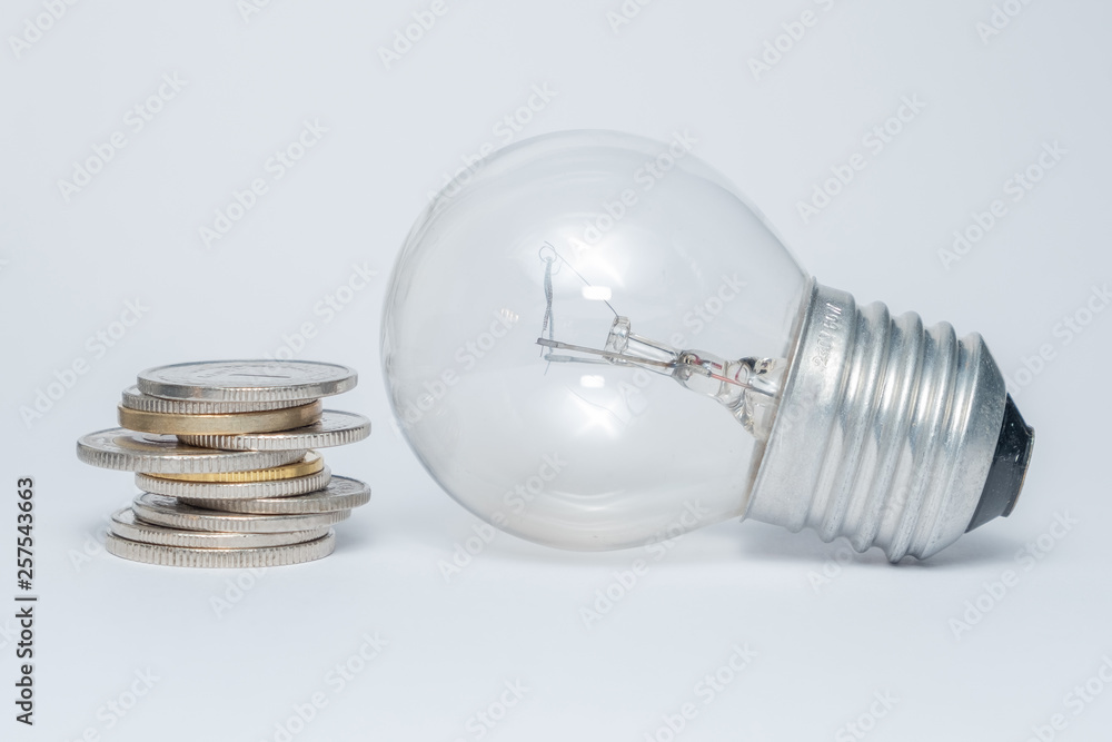 Light bulb with heap of coins stairs for financial plan or business idea concept - Imagen