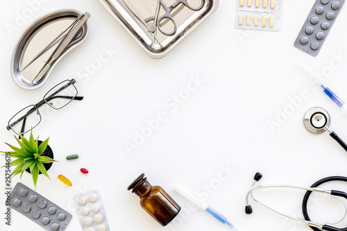 work desk of doctor in hospital with medical set on frame white background top view mockup